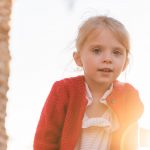cute child near palm tree during vacation